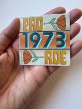 Load image into Gallery viewer, Pro-choice vinyl matte sticker supporting abortion rights, designed in a retro 1973 Roe v. Wade style with vibrant feminist graphics.