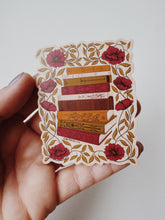 Load image into Gallery viewer, Vinyl matte sticker illustrating a &#39;To Be Read&#39; stack of books in a nostalgic vintage design.